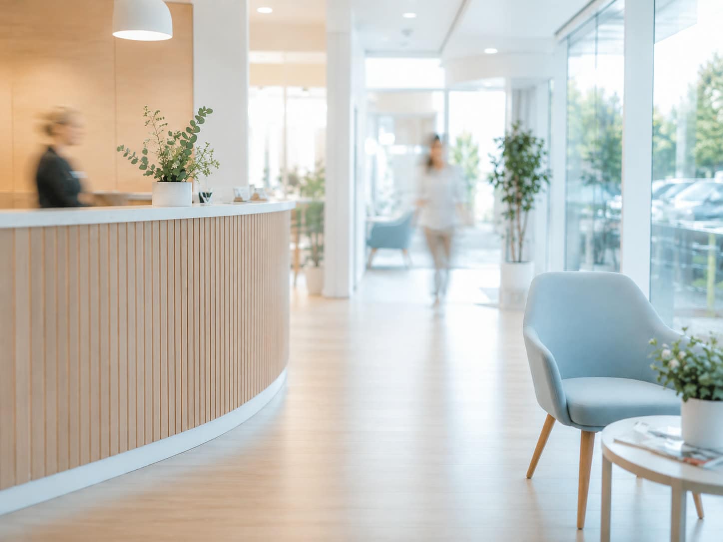 A practice reception with a patient walking through.